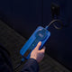 Hand holding the control box of the Voldt® Type 1 Portable Charger at night